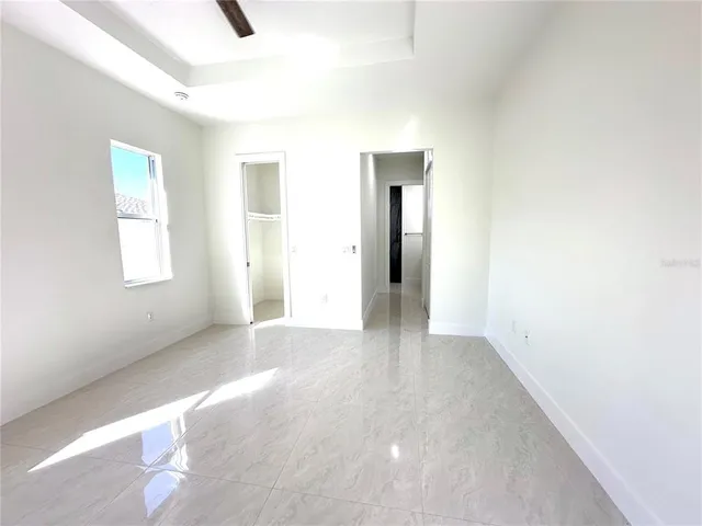 an empty room with windows and closet