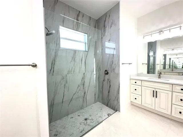 a spacious bathroom with a shower and a sink