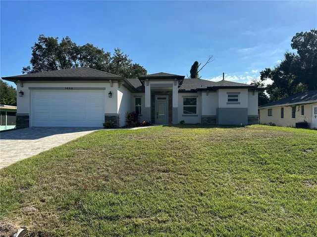 a front view of a house with a yard and garage