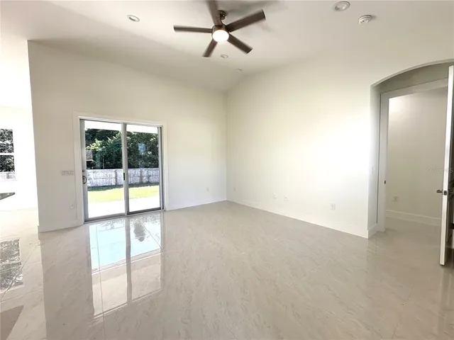 an empty room with windows and outdoor view
