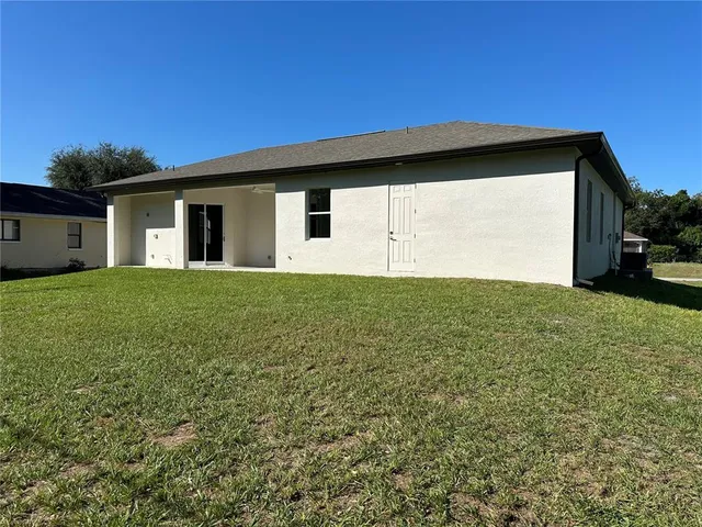 a big house with a big yard and large trees