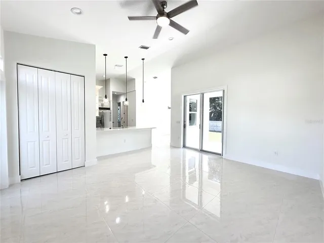 a view of a livingroom with a ceiling fan and window
