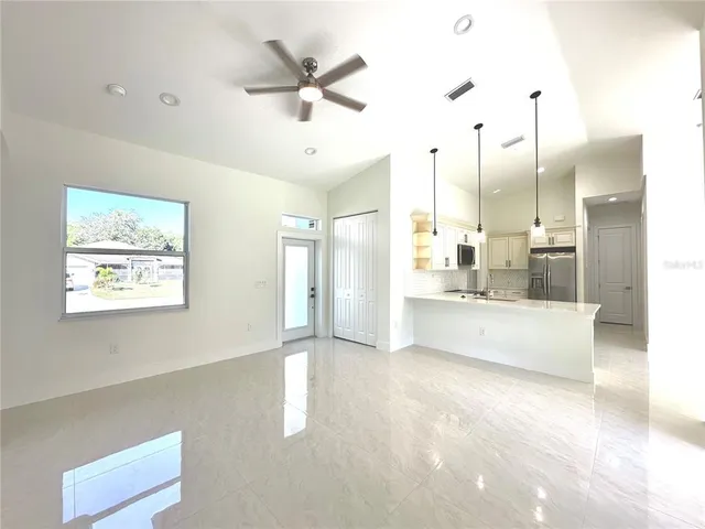 a large white kitchen with a large window