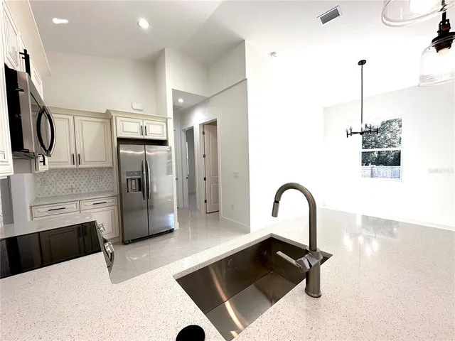 a kitchen with a refrigerator and a sink