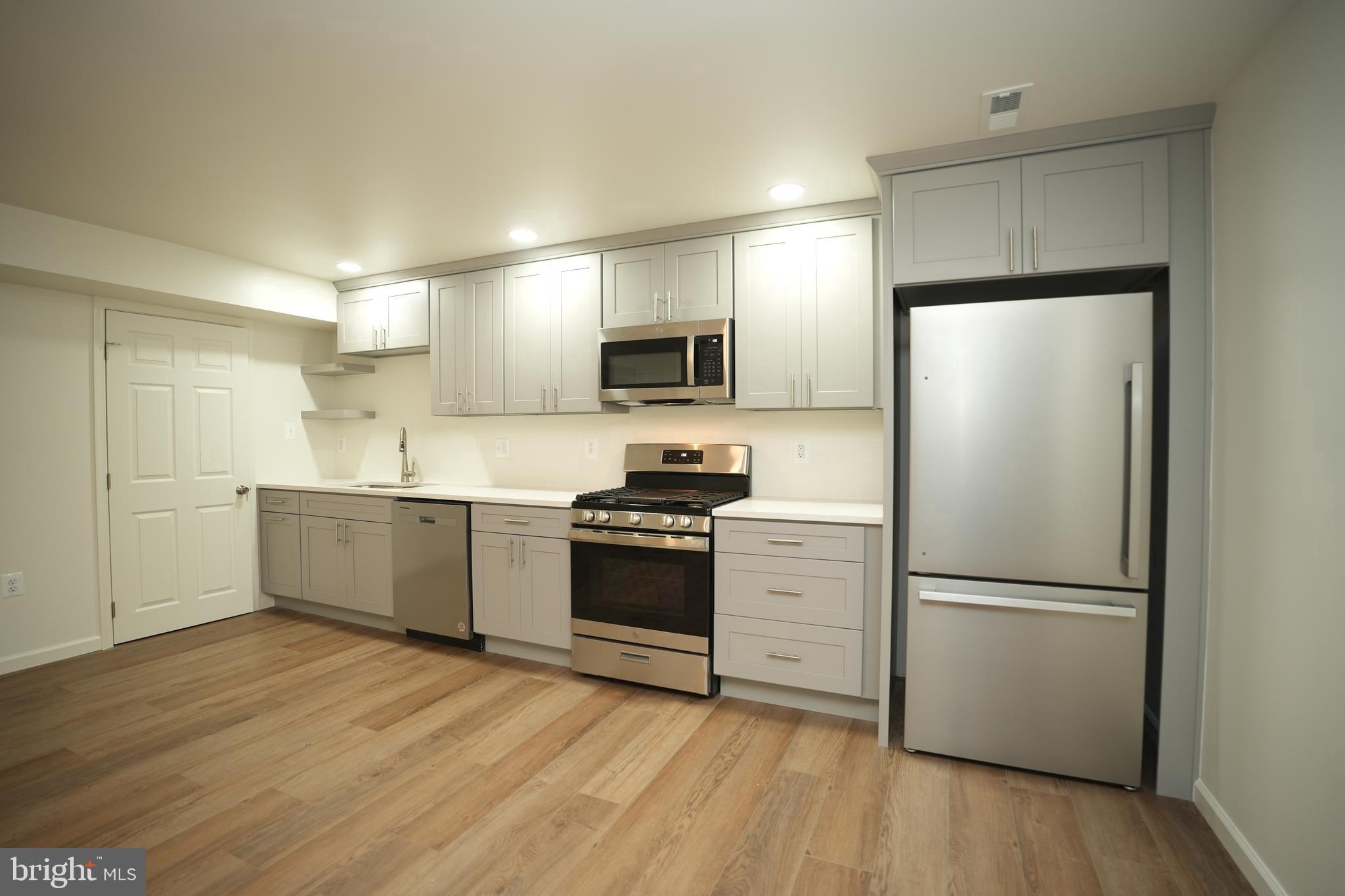 22271 Goldenrod Drive, Unit BASEMENT APARTMENT Great Mills, MD 20634 - Photo 1 of 15 a kitchen with a refrigerator and a stove top oven