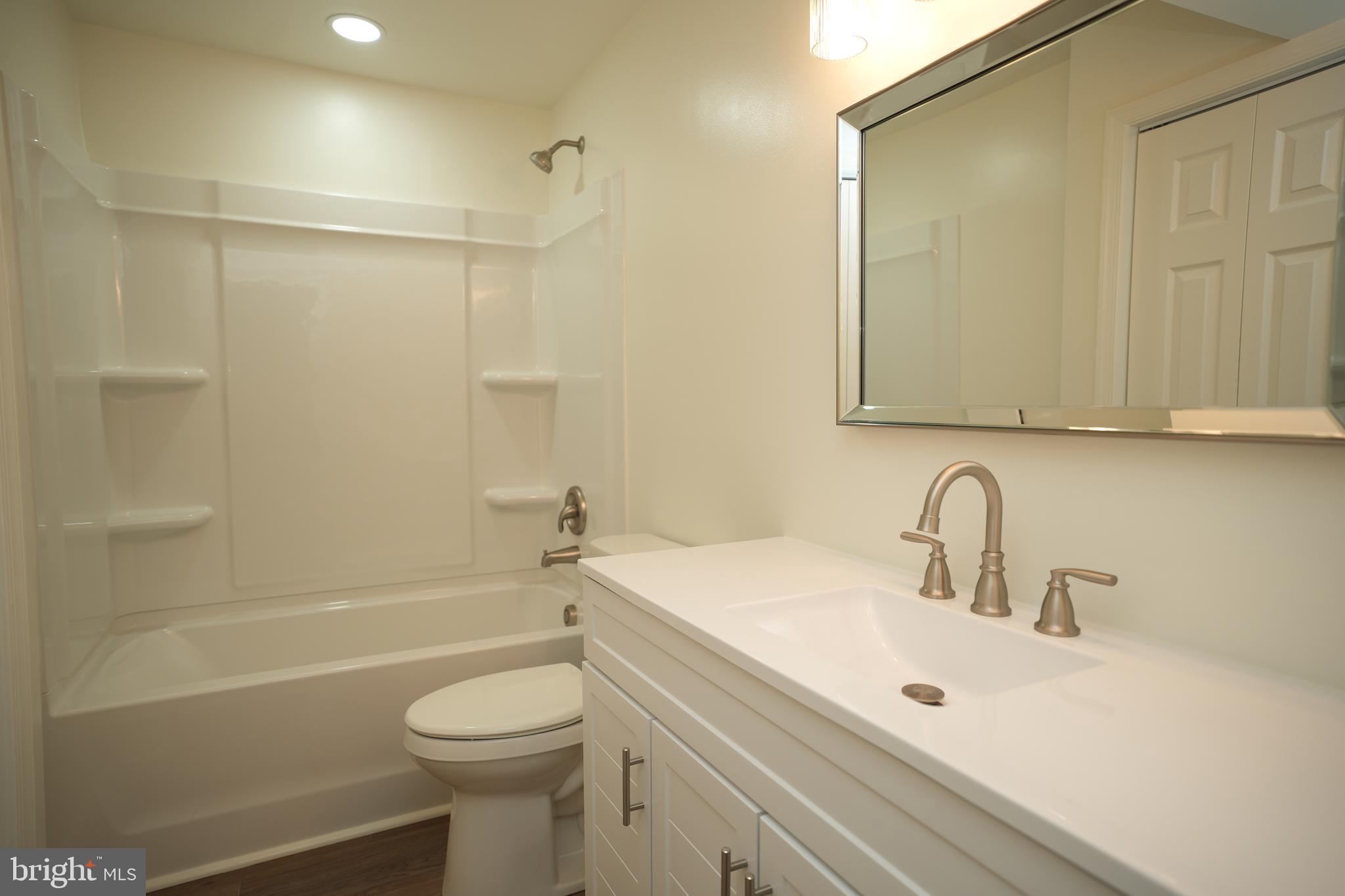 22271 Goldenrod Drive, Unit BASEMENT APARTMENT Great Mills, MD 20634 - Photo 12 of 15 a bathroom with a sink a toilet and shower