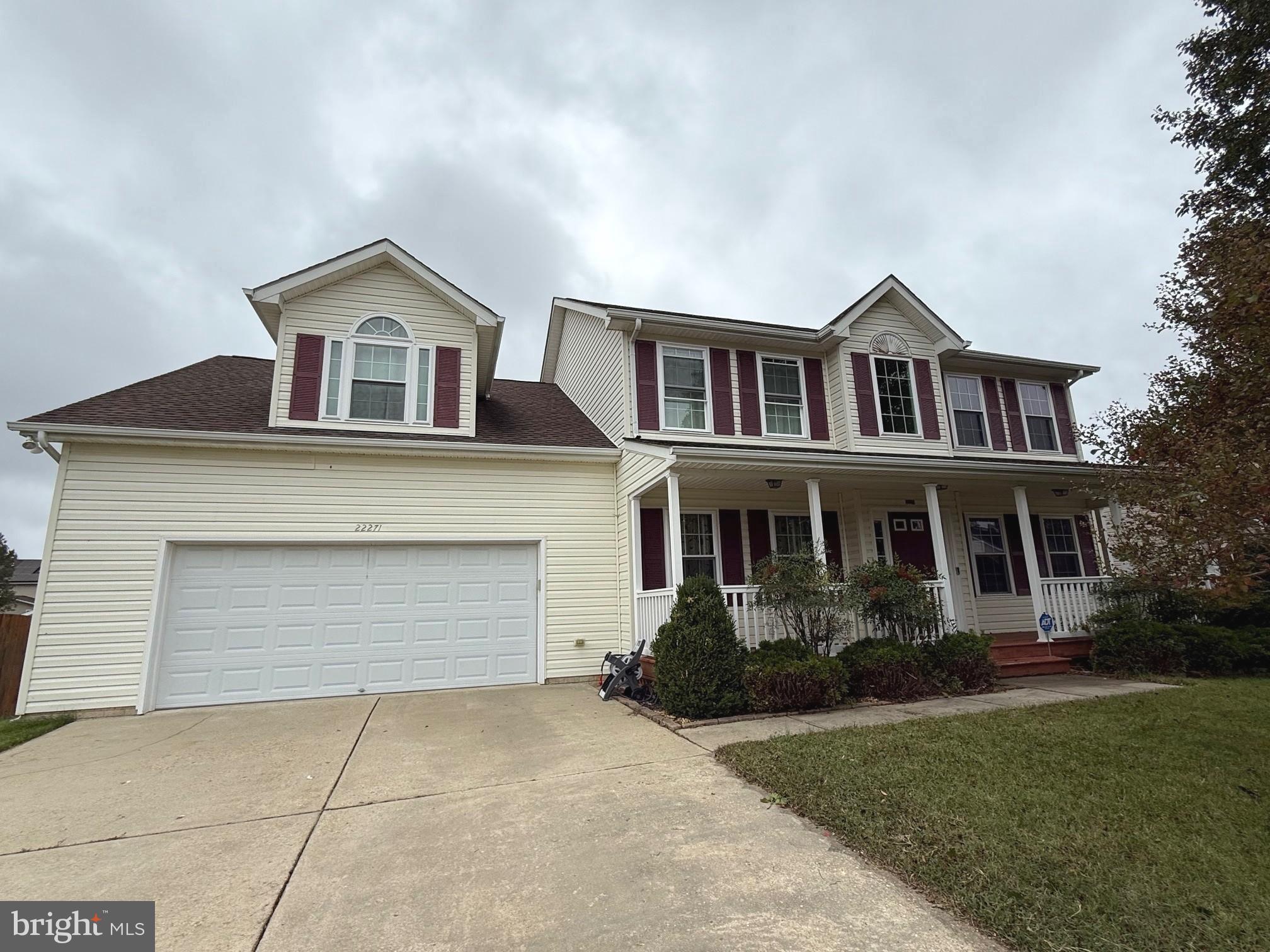 22271 Goldenrod Drive, Unit BASEMENT APARTMENT Great Mills, MD 20634 - Photo 15 of 15 a front view of a house with a yard and garage