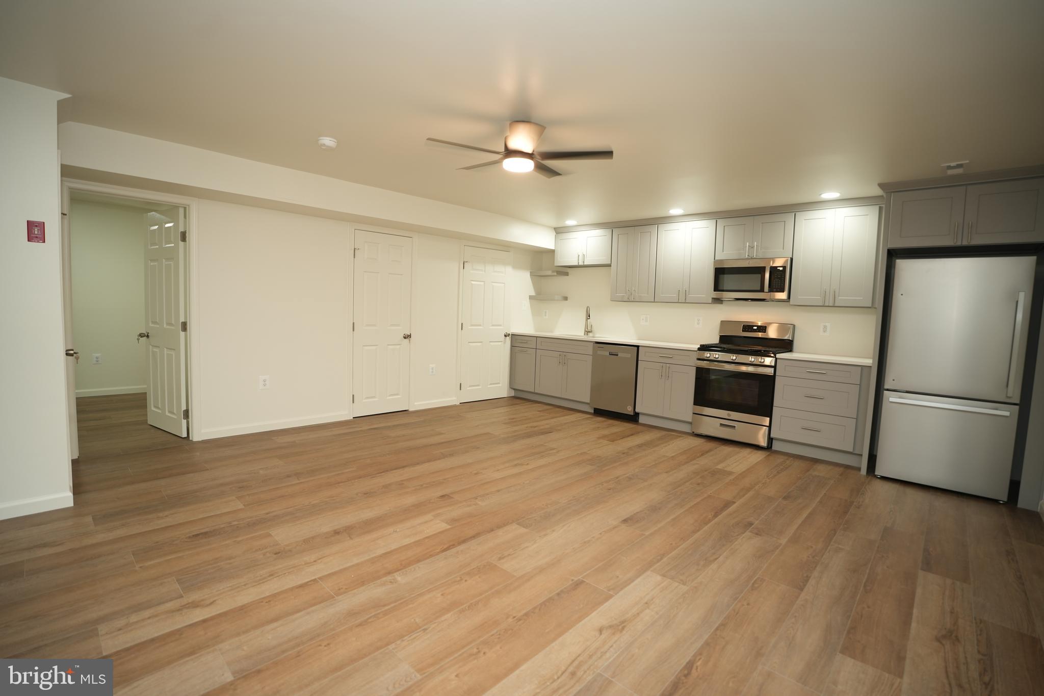 22271 Goldenrod Drive, Unit BASEMENT APARTMENT Great Mills, MD 20634 - Photo 6 of 15 a large kitchen with a refrigerator and a stove top oven