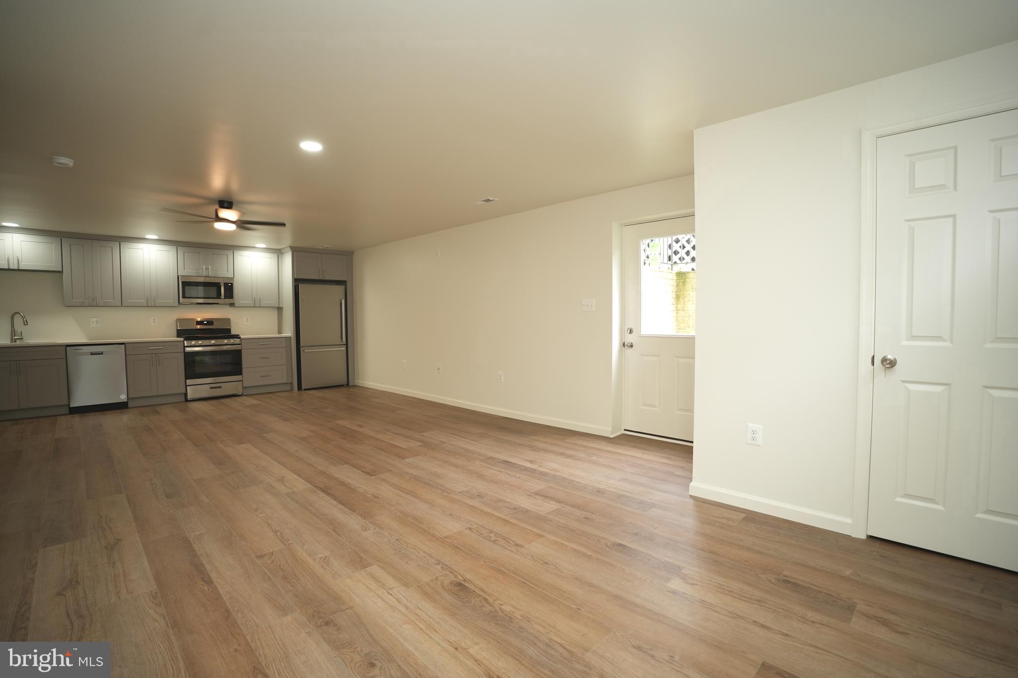 22271 Goldenrod Drive, Unit BASEMENT APARTMENT Great Mills, MD 20634 - Photo 7 of 15 an empty room with wooden floor and windows