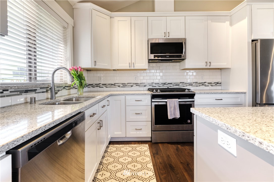 1007 Ridge Lane Everson, WA 98247 - Photo 11 of 25 a kitchen with stainless steel appliances granite countertop a stove a sink and a microwave