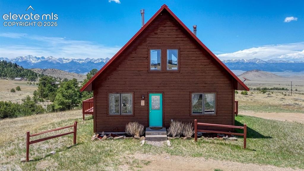 489 Excelsior Road Westcliffe, CO 81252 - Photo 1 of 34 a front view of a house with garden