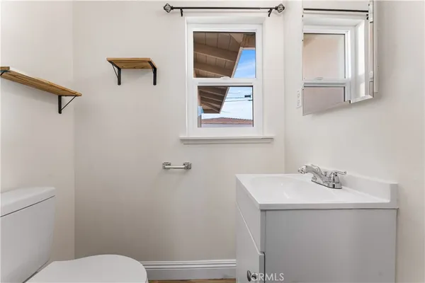 a bathroom with a sink mirror and toilet