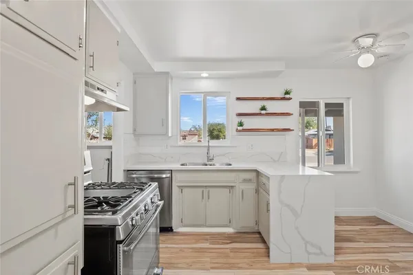 a kitchen with a stove sink and cabinets
