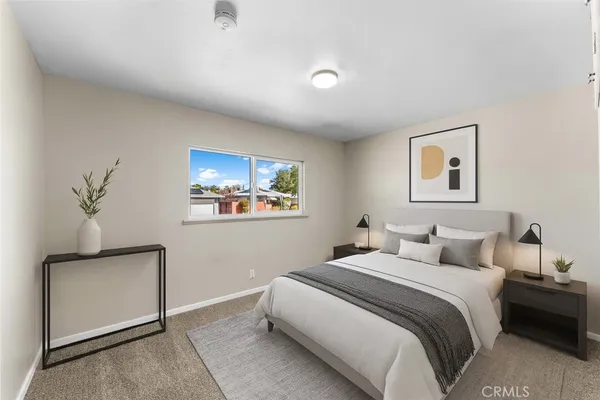 a bedroom with a bed and a painting on the wall