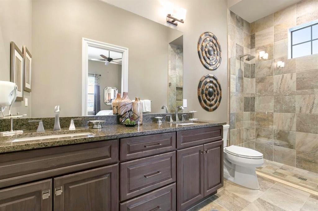 1261 Radiant Street Reunion, FL 34747 - Photo 82 of 100 a bathroom with a toilet a sink and a mirror