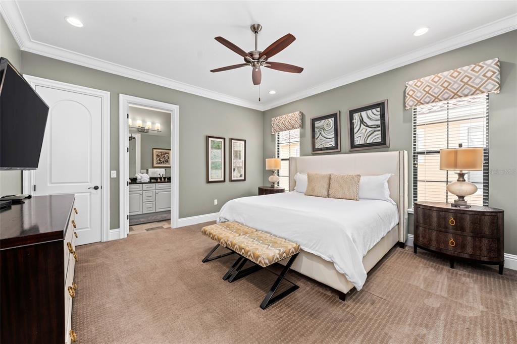 1261 Radiant Street Reunion, FL 34747 - Photo 83 of 100 a bedroom with a large bed and a tv
