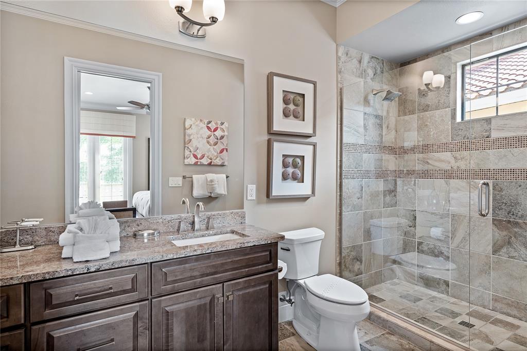 1261 Radiant Street Reunion, FL 34747 - Photo 91 of 100 a bathroom with a granite countertop toilet sink and a mirror