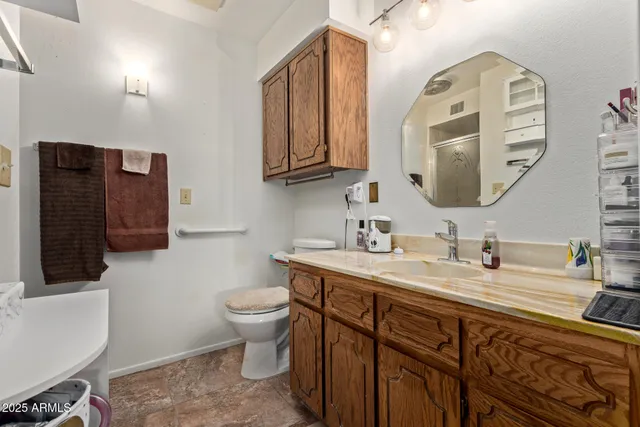a bathroom with a toilet sink and mirror