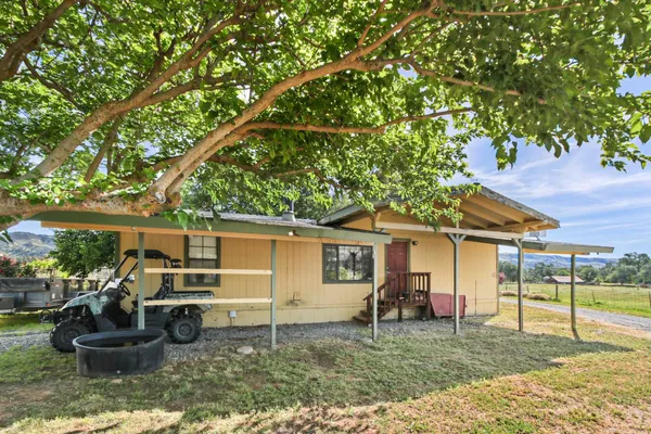 a backyard of a house with yard and outdoor seating