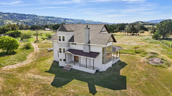 a view of a house with a yard and mountain view