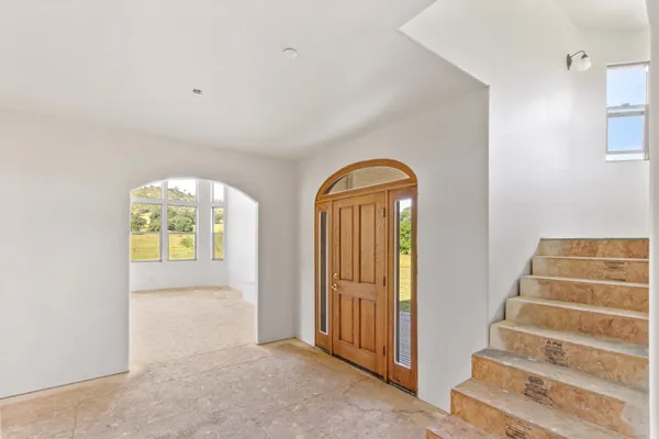 a view of an entryway with wooden floor