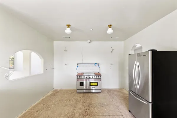 a view of a refrigerator in kitchen and livingroom