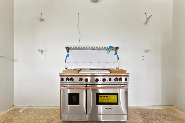 a stove top oven sitting inside of a kitchen