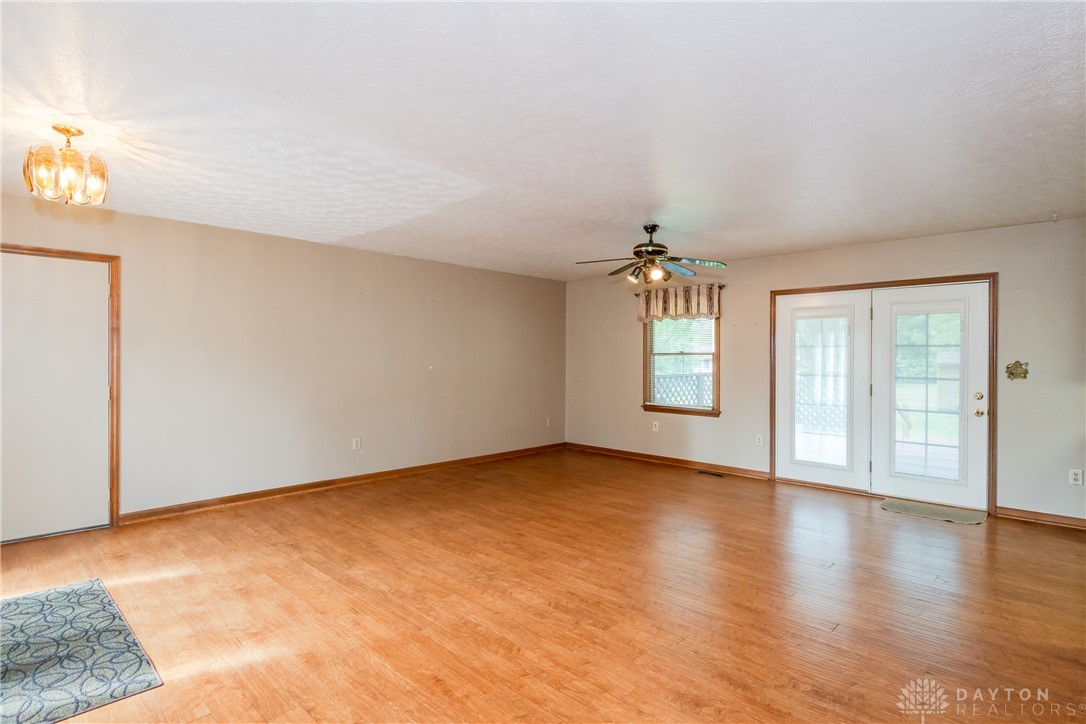 This inviting space offers durable flooring, a ceiling fan, and access to outdoor living.