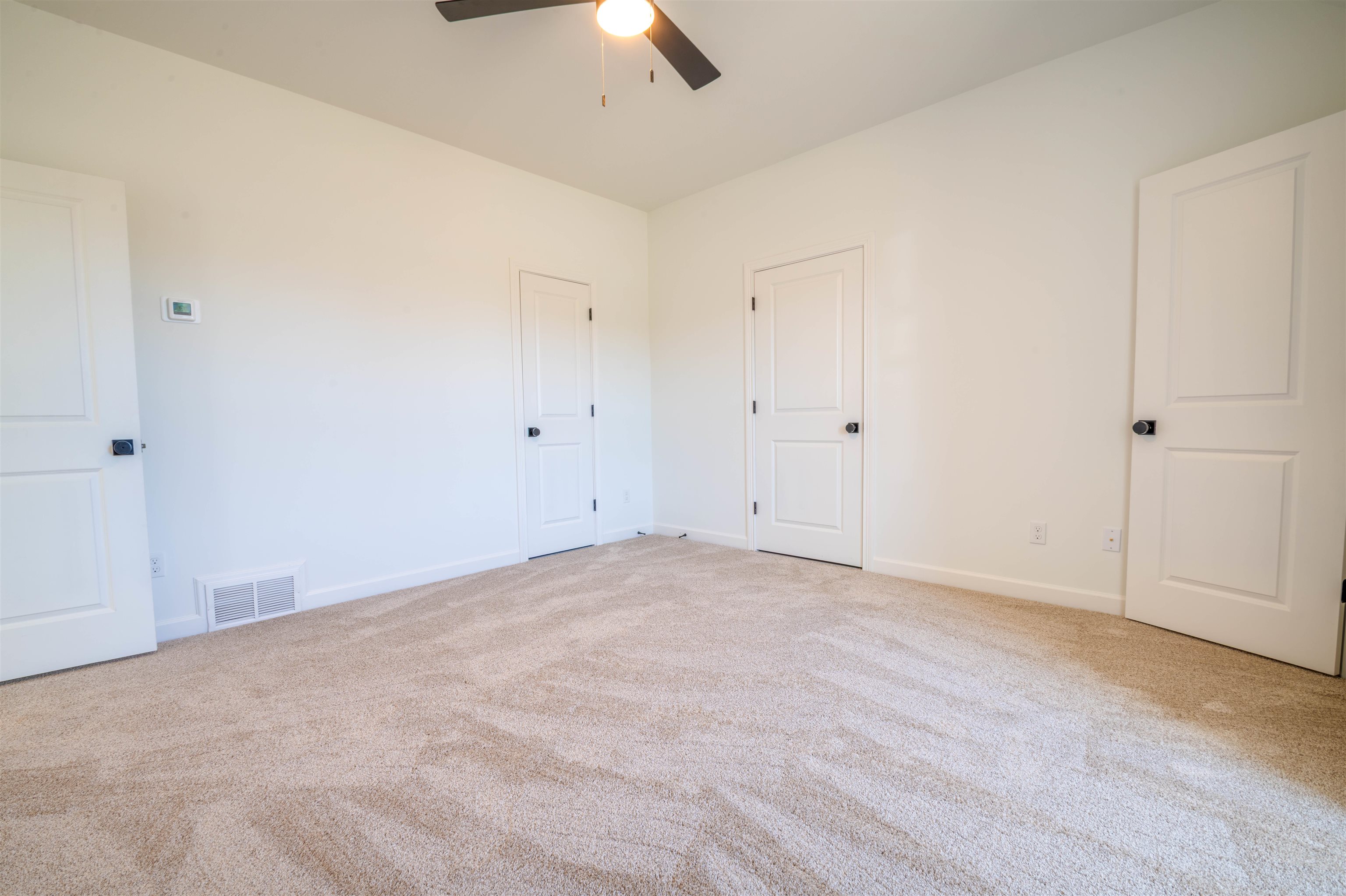 30 Rambling Rex Trail Piperton, TN 38017 - Photo 17 of 25 Unfurnished bedroom with a ceiling fan, carpet flooring, baseboards, and visible vents
