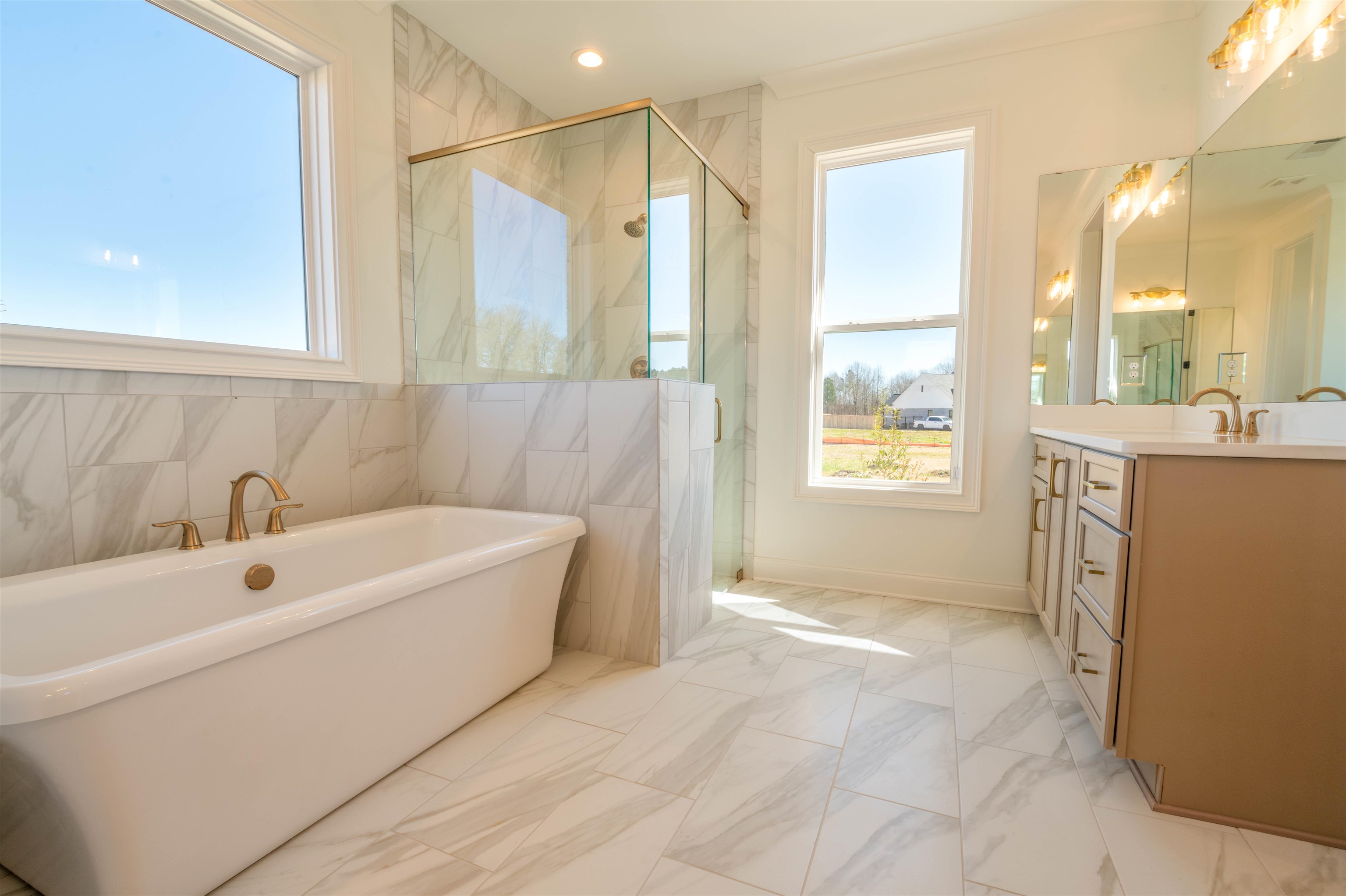 30 Rambling Rex Trail Piperton, TN 38017 - Photo 20 of 25 Bathroom with vanity, marble finish floor, a shower stall, and a healthy amount of sunlight