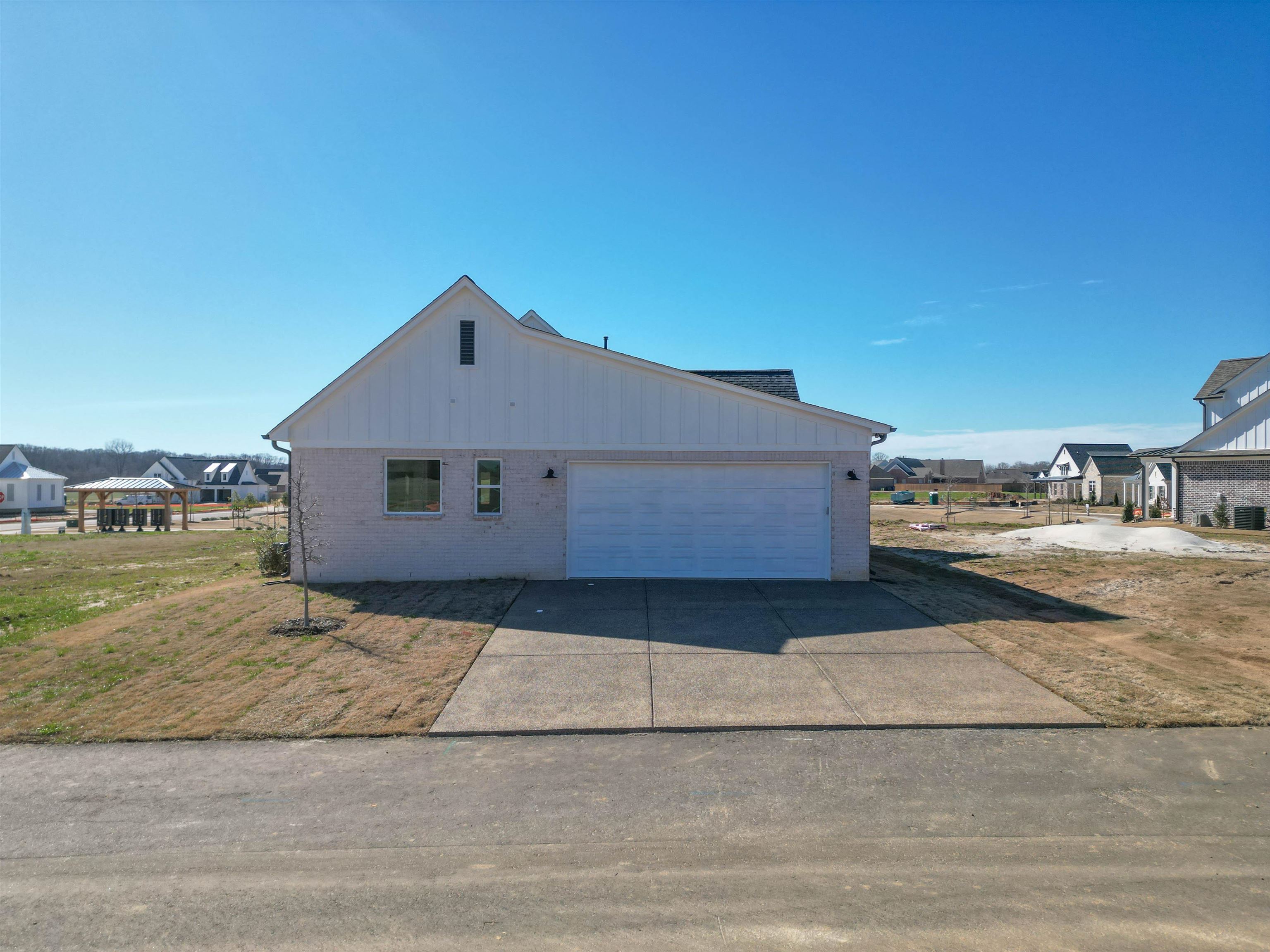 30 Rambling Rex Trail Piperton, TN 38017 - Photo 24 of 25 View of home's exterior featuring concrete driveway, a garage, and brick siding