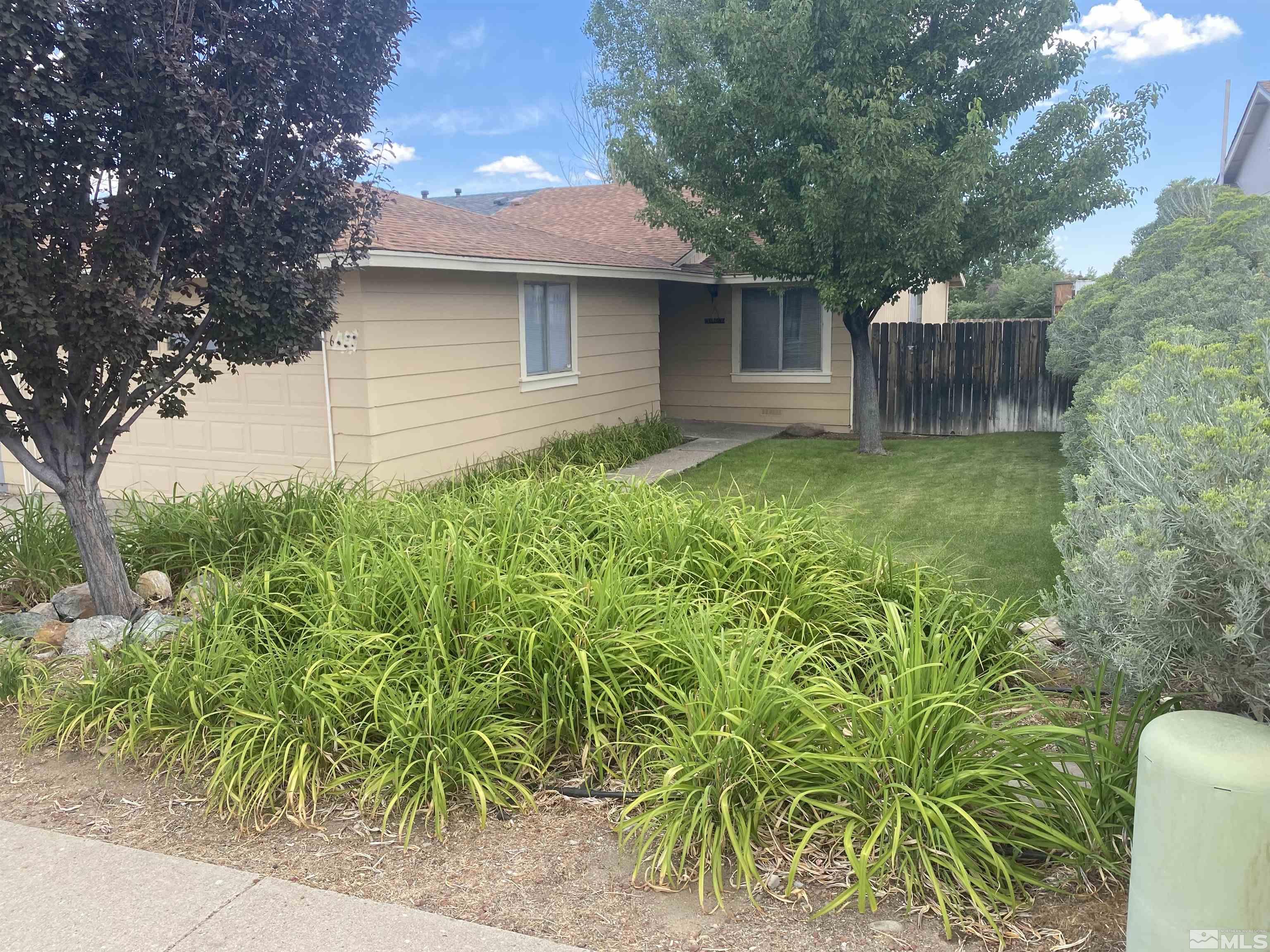 6788 Flower Street Reno, NV 89506 - Photo 1 of 23 a backyard of a house with lots of green space