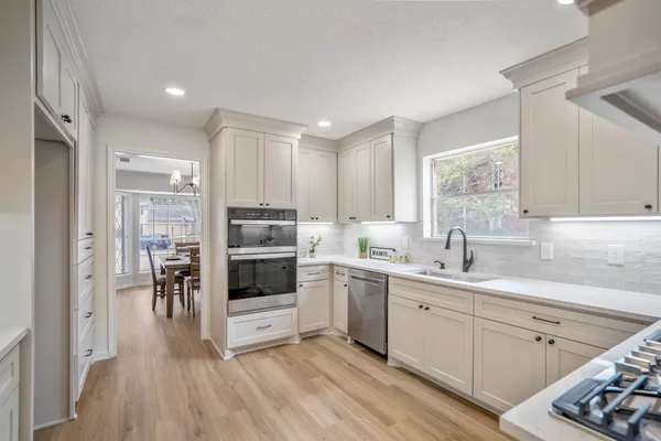 a kitchen with a sink cabinets and window