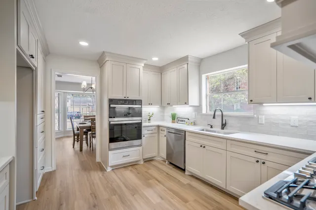 a kitchen with a sink cabinets and window