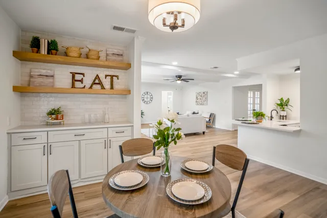 a view of a dining room with furniture and wooden floor