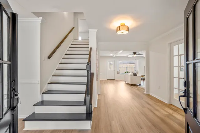 a view of a hallway with wooden floor fireplace and living room