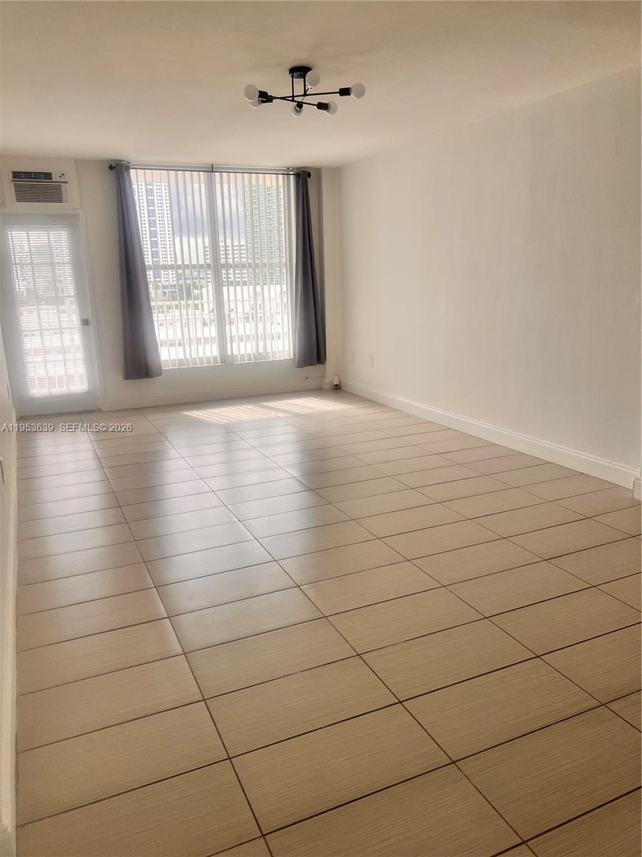 1300 Lincoln Road, Unit B902 Miami Beach, FL 33139 - Photo 4 of 17 wooden floor in an empty room with a window