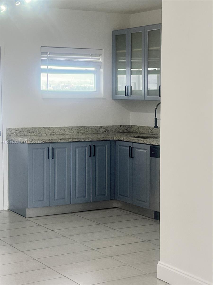 1300 Lincoln Road, Unit B902 Miami Beach, FL 33139 - Photo 8 of 17 a view of kitchen with granite countertop cabinets and window