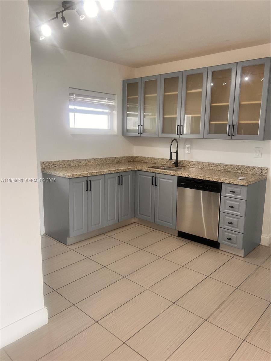 1300 Lincoln Road, Unit B902 Miami Beach, FL 33139 - Photo 9 of 17 a kitchen with stainless steel appliances granite countertop a sink and a granite counter tops with a large window