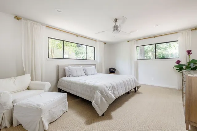 a bedroom with bed and a chandelier
