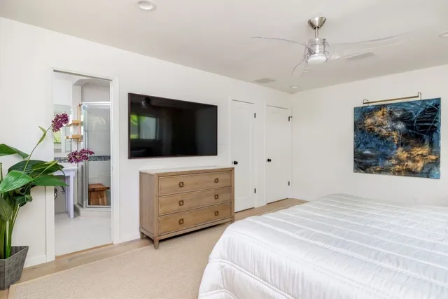 a bedroom with a bed and a flat screen tv