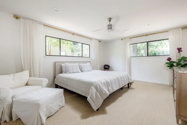 a bedroom with bed and a chandelier