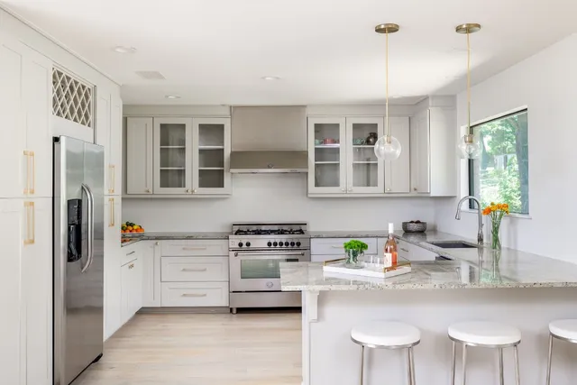 a kitchen with stainless steel appliances a sink and cabinets