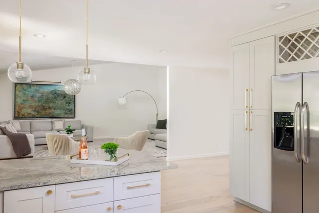 a kitchen with stainless steel appliances granite countertop a refrigerator and a sink