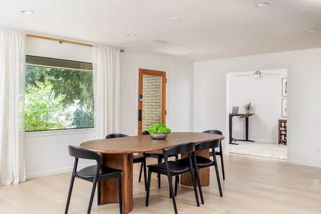 a view of a dining room with furniture and a window