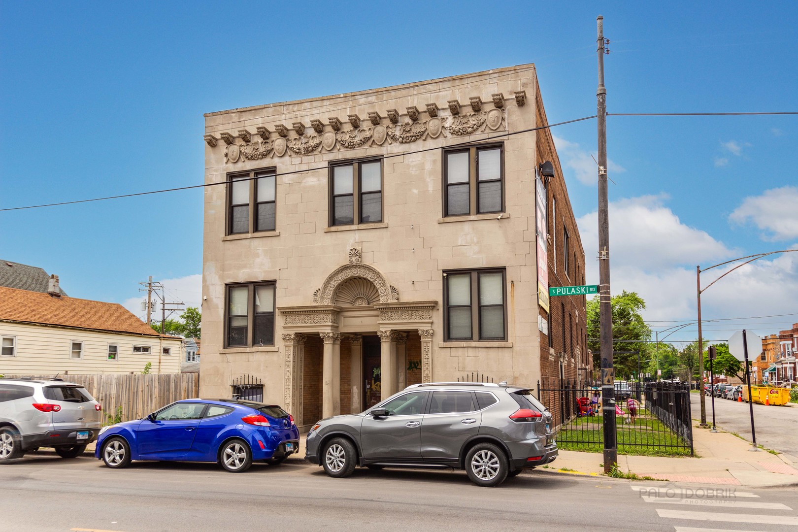 a view of a cars park in front of a building