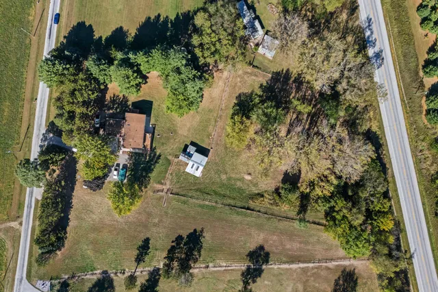 an aerial view of a house with a yard
