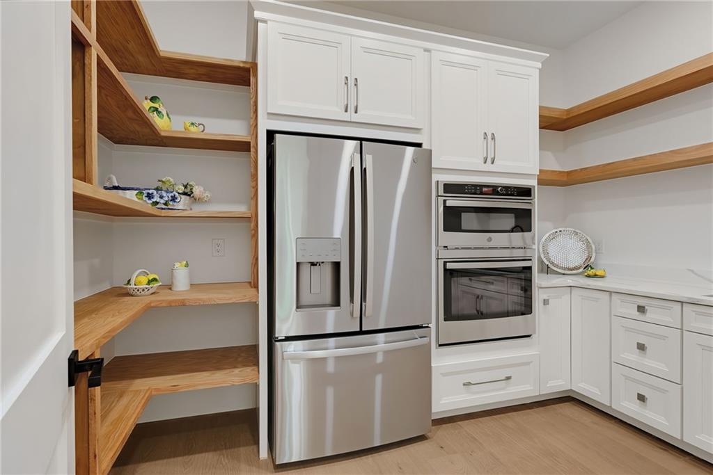 2366 Wall Road Monroe, GA 30656 - Photo 122 of 186 a kitchen with white cabinets and white appliances