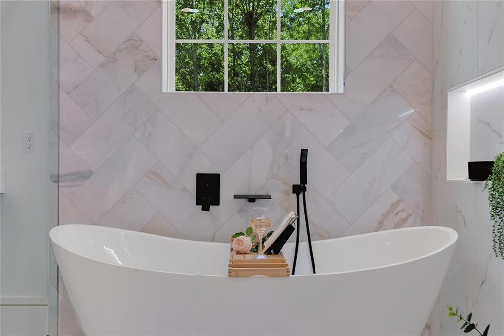 2366 Wall Road Monroe, GA 30656 - Photo 131 of 186 a white bath tub sitting in a bathroom