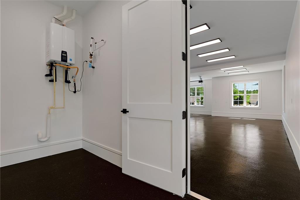 2366 Wall Road Monroe, GA 30656 - Photo 142 of 186 an empty room with wooden floor closet and windows